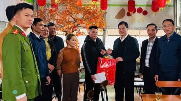 Đại tá Vũ Hồng Quang - Giám đốc Công an tỉnh Cao Bằng (thứ 3 từ phải qua) cùng các thành viên đoàn công tác của Ngân hàng Chính sách xã hội, Công an tỉnh Cao Bằng tặng quà Tết cho hộ vay vốn chấp hành xong án phạt tù. 