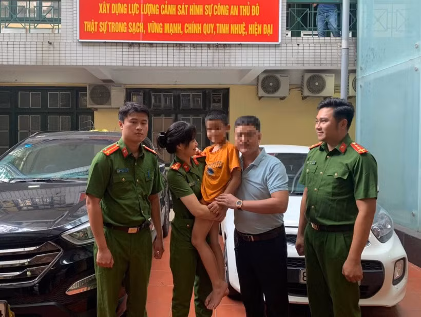 Lực lượng công an đưa cháu bé về với gia đình.