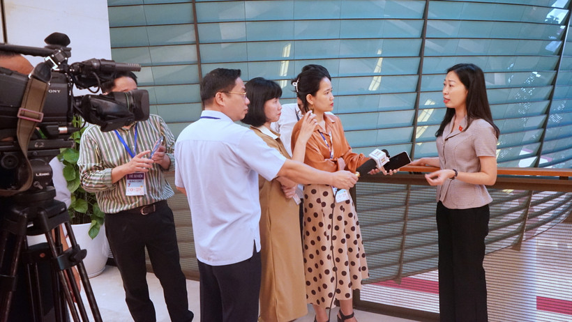 Phóng viên các cơ quan thông tấn, báo chí tác nghiệp tại hành lang Quốc hội trong khuôn khổ Kỳ họp thứ 7. (Ảnh: TRUNG HƯNG) 