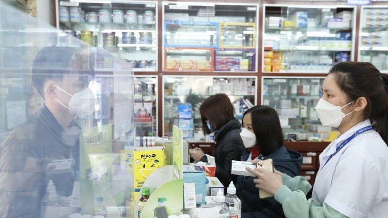 Nhân viên cửa hàng thuốc hướng dẫn khách sử dụng thuốc. (Ảnh minh họa: TTXVN) 