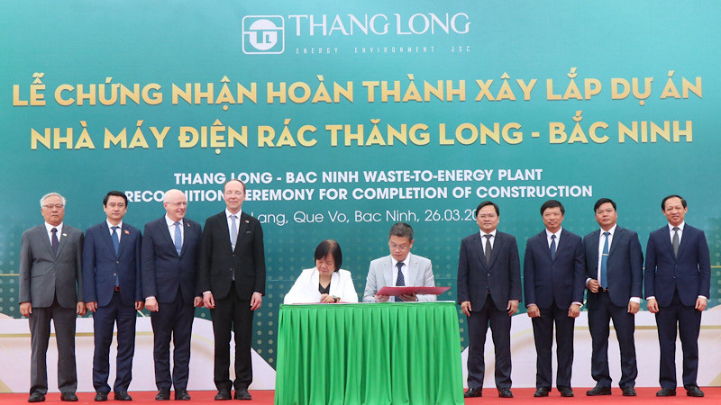 Các đại biểu chứng kiến lễ ký kết bàn giao chứng nhận hoàn thành xây lắp dự án nhà máy.