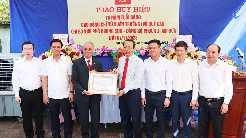 Đồng chí Nguyễn Quốc Chung, Phó Bí thư Tỉnh ủy Bắc Ninh trao Huy hiệu 75 năm tuổi Đảng tặng đảng viên Vũ Xuân Trường, ở phường Tam Sơn, thành phố Từ Sơn.