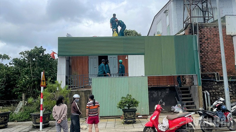 Các lực lượng Công an, dân quân xã Bảo Lâm 3, tỉnh Lâm Đồng, hỗ trợ một hộ dân lợp lại mái nhà bị tốc do ảnh hưởng bão số 3. ndo_br_dd.jpg