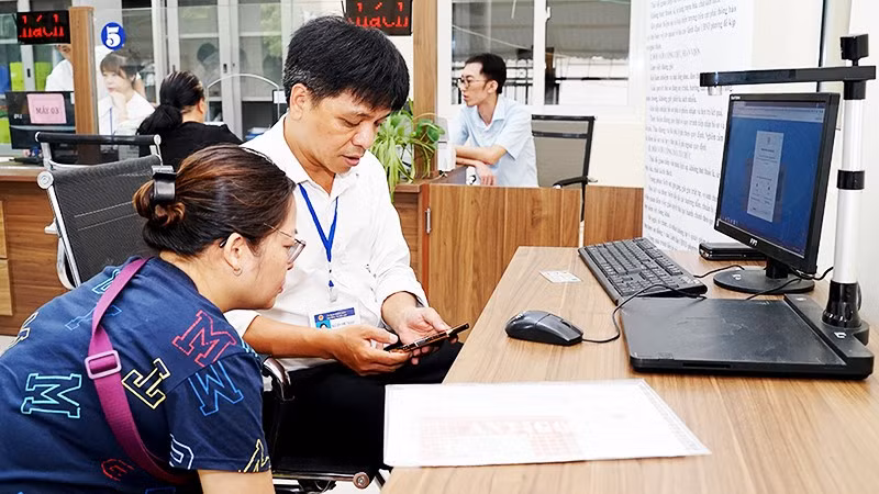 Hướng dẫn người dân sử dụng VNeID để làm thủ tục hành chính tại phường, xã. Ảnh: BẮC SƠN