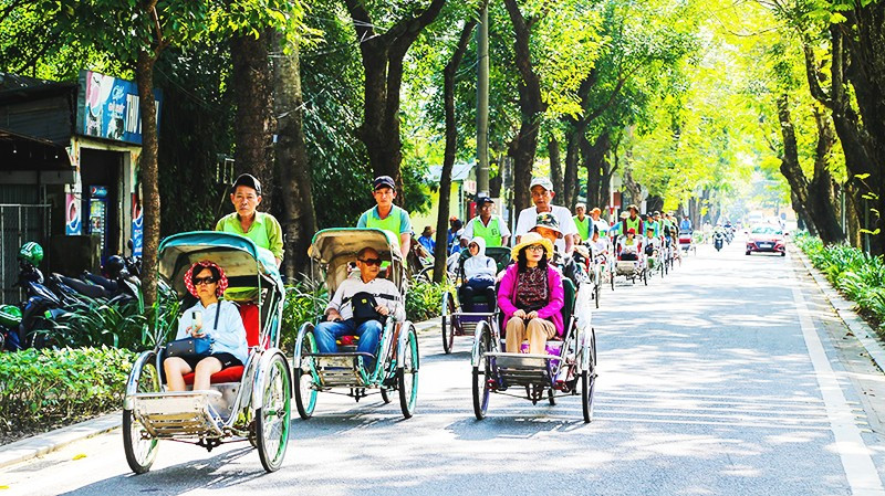 Du khách trải nghiệm khám phá du lịch xanh tại Huế bằng xích-lô.