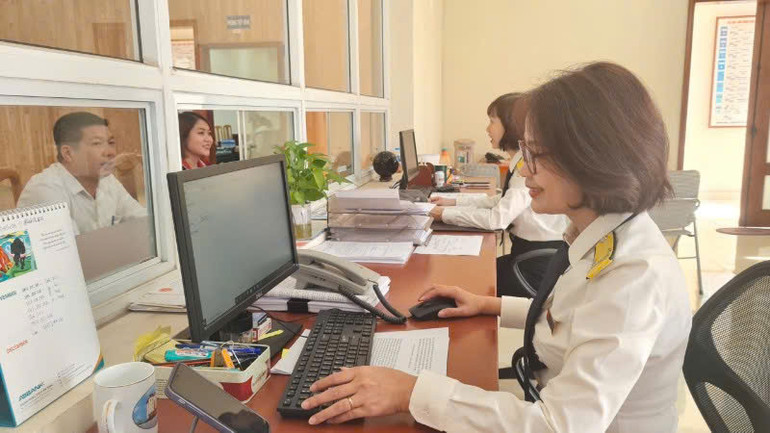 Cán bộ Chi cục Thuế Vĩnh Phúc hướng dẫn doanh nghiệp các chính sách thuế mới.