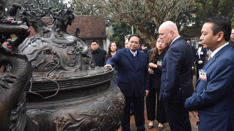 Thủ tướng Phạm Minh Chính giới thiệu với Thủ tướng New Zealand Christopher Luxon về đỉnh đồng tại Văn Miếu-Quốc Tử Giám. (Ảnh: TRẦN HẢI)