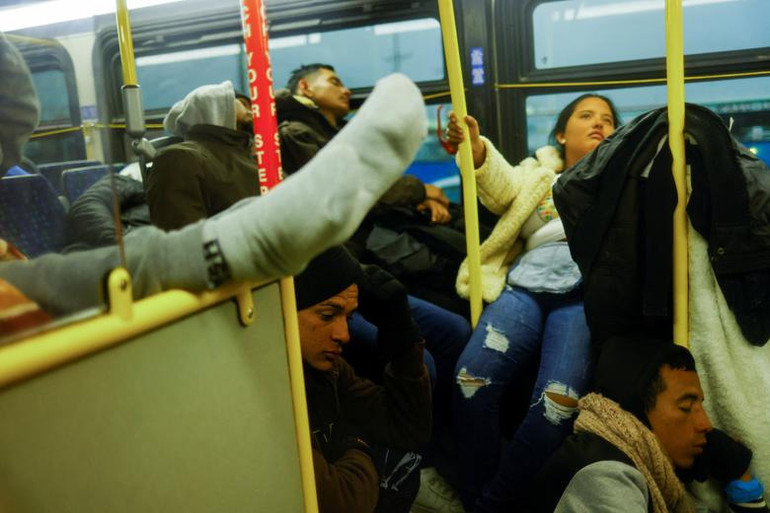 Người di cư, phần lớn đến từ Venezuela, lên xe buýt để tránh cảnh rét buốt khi nhiệt độ giảm mạnh về đêm tại El Paso, bang Texas, Mỹ, ngày 23/12. (Ảnh: Reuters)