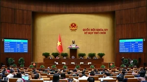 Quốc hội biểu quyết thông qua Bộ luật Tố tụng hình sự. (Ảnh: DUY LINH)