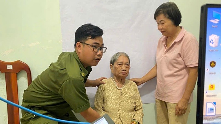 Công an phường Tân Ninh mang theo thiết bị chụp ảnh, máy tính và đầy đủ biểu mẫu cần thiết để thực hiện quy trình đổi thẻ đảng viên tại nhà. (Ảnh: Công an Tây Ninh) ca-4-2.jpg