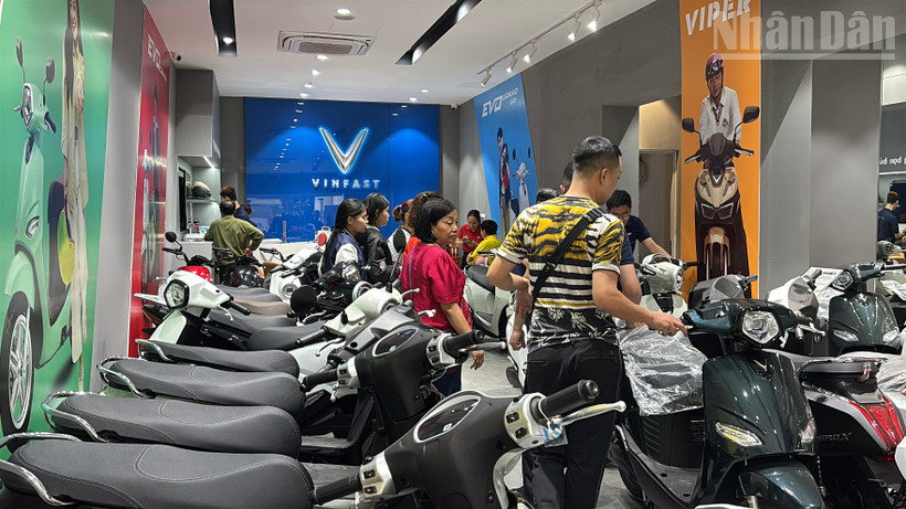 Nhân viên cửa hàng tư vấn cho khách về các mẫu xe điện mới nhất 2026.