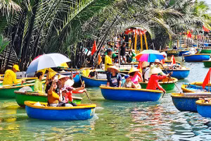 Du khách tham quan rừng dừa Cẩm Thanh bằng thuyền thúng (thuyền chai).