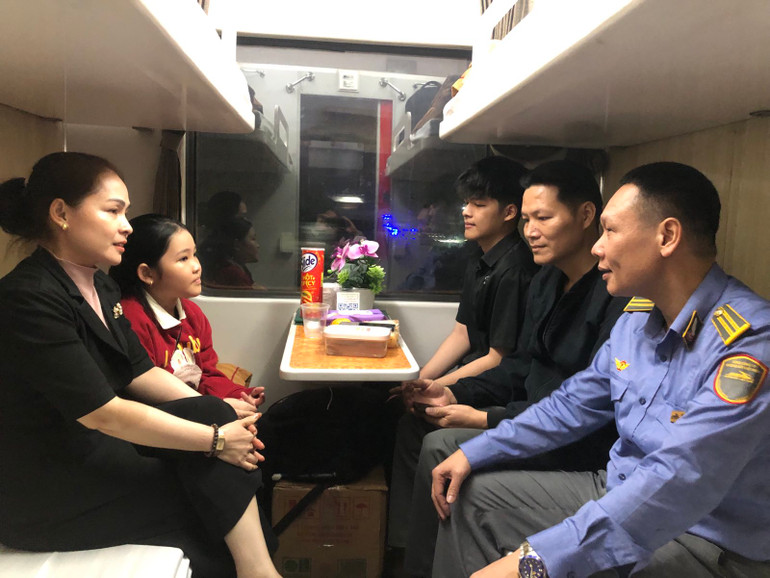 Trưởng tàu Đoàn Anh Tuấn trò chuyện với hành khách trên tàu Tết. Trưởng tàu Đoàn Anh Tuấn trò chuyện với hành khách trên tàu Tết.