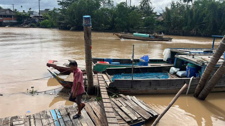 Nhiều ghe chở thủy sản tại chợ Mỏ Cày gặp khó khăn khi bị rào chắn bến sông. (Ảnh: HOÀNG TRUNG)