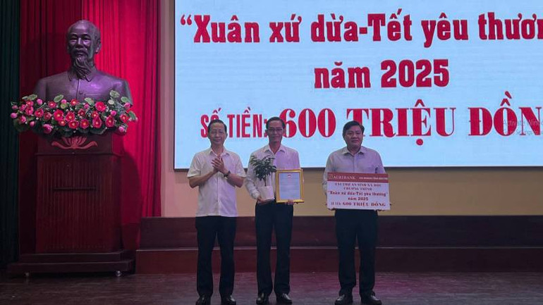 Đại diện Agribank, Chi nhánh Bến Tre trao hỗ trợ 600 triệu đồng cho Chương trình "Xuân xứ Dừa-Tết yêu thương". (Ảnh: HOÀNG TRUNG)