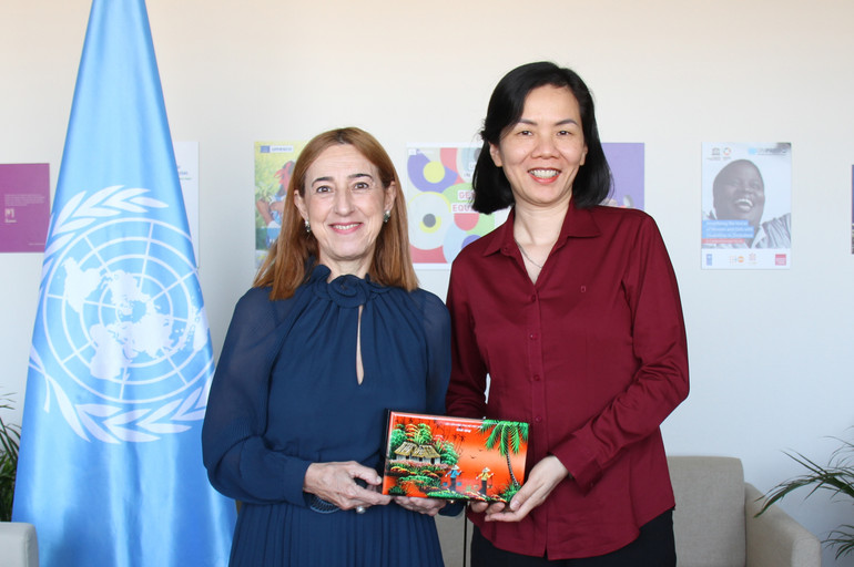 Phó Chủ tịch Hội Liên hiệp Phụ nữ Việt Nam Nguyễn Thị Minh Hương tặng quà lưu niệm cho bà Begona Lasagabaster, Vụ trưởng phụ trách về bình đẳng giới của UNESCO. (Ảnh: Minh Duy)