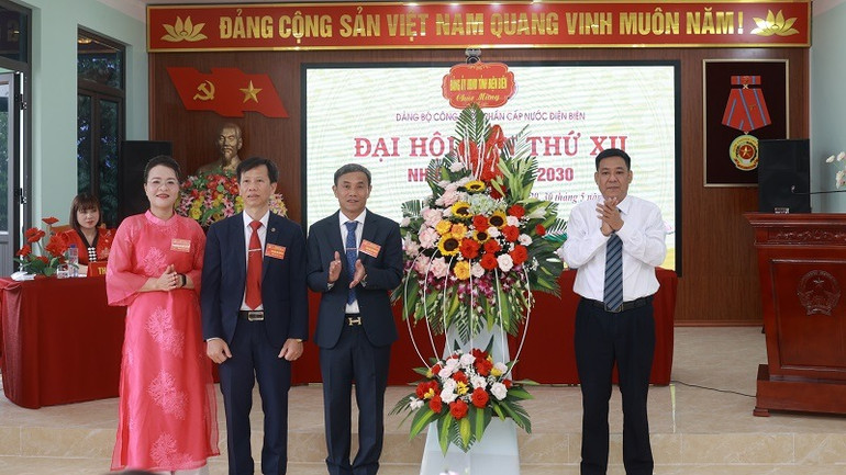 Đồng chí Nguyễn Duy Chinh, Phó Bí thư Đảng bộ Ủy ban nhân dân tỉnh Điện Biên tặng hoa chúc mừng Đại hội 12 của Công ty cổ phần cấp nước Điện Biên.