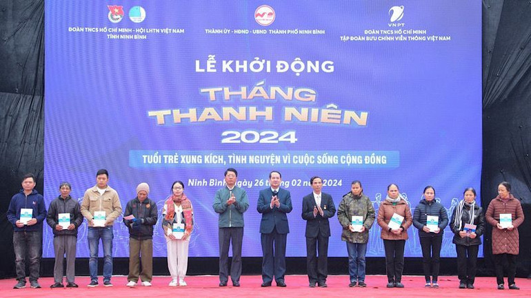 Các đại biểu trao tặng thẻ bảo hiểm y tế cho người có hoàn cảnh khó khăn. Ảnh: NGỌC HÀ