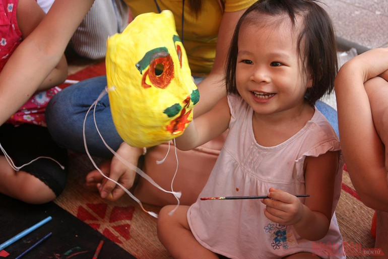 Em bé với niềm vui khi vẽ chiếc mặt nạ đầu tiên trong đời. Trung thu và di sản tinh thần -0