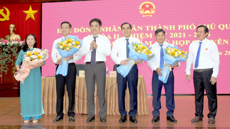 Bí thư Thành ủy Phú Quốc Lê Quốc Anh (thứ 3 từ trái qua) tặng hoa chúc mừng tân Chủ tịch Ủy ban nhân dân thành phố Phú Quốc Trần Minh Khoa (thứ 2 từ trái qua).