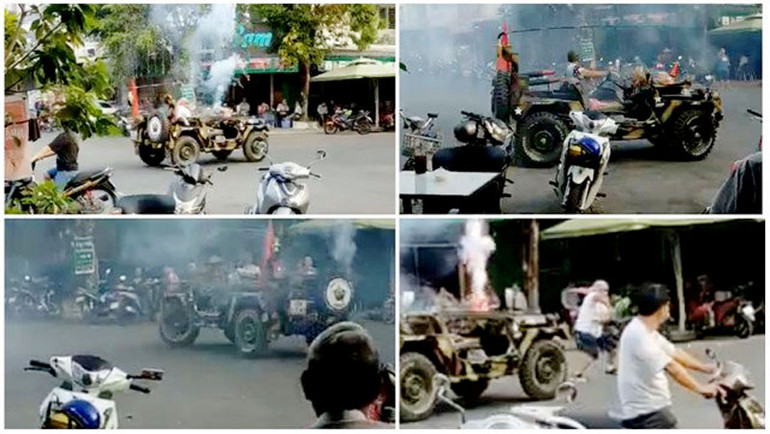 Hiệu ngồi trên xe jeep đốt pháo sáng, quay xe vòng tròn gây náo loạn đường phố. (Ảnh: VĂN VŨ)