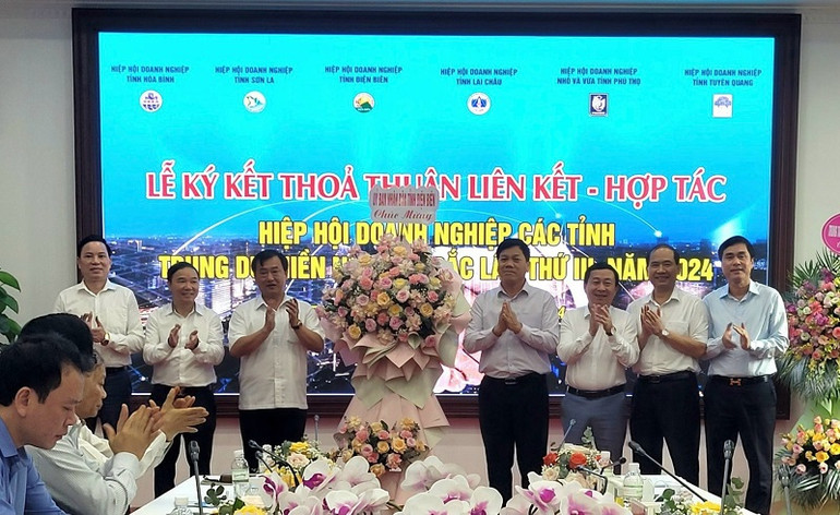 Đồng chí Vừ A Bằng, Phó Chủ tịch Ủy ban nhân dân tỉnh Điện Biên tặng hoa, chúc mừng hội nghị của Hiệp hội doanh nghiệp 6 tỉnh.