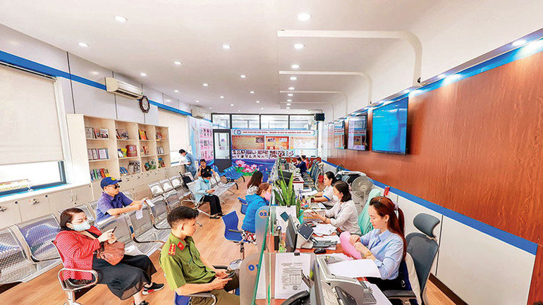 Nhân viên ngành cấp nước hướng dẫn khách hàng làm hợp đồng cấp nước điện tử.