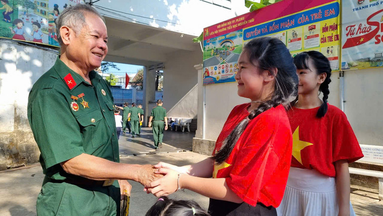 Cựu chiến binh giao lưu với các em học sinh.