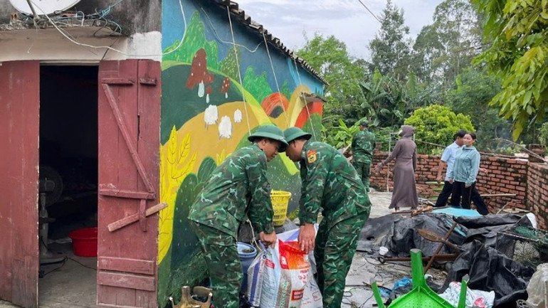 Cán bộ, chiến sĩ Đồn Biên phòng Cửa khẩu cảng Vạn Gia giúp người dân trên các xã đảo Vĩnh Thực và Vĩnh Trung gia cố nhà cửa.