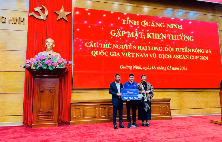 Đại diện lãnh đạo Câu lạc bộ Bóng đá Quảng Ninh thưởng 100 triệu đồng cho cầu thủ Nguyễn Hai Long.