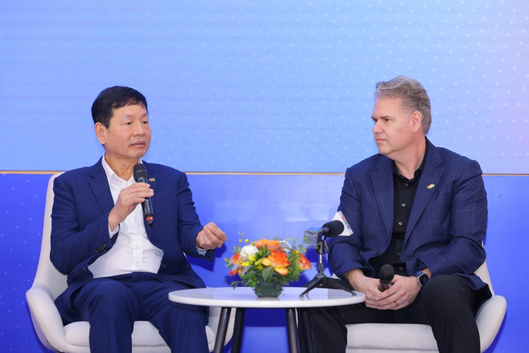 Ông Trương Gia Bình và ông Keith Strier trong cuộc trao đổi sau lễ ký kết.