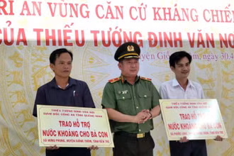 Thiếu tướng Đinh Văn Nơi trao bảng tượng trưng hỗ trợ nước khoáng cho người dân vùng hạn mặn tại tỉnh Bến Tre.