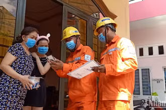 Công nhân ngành điện tuyên truyền cho các gia đình về tiết kiệm điện và giá bán điện theo quy định hiện hành. 
