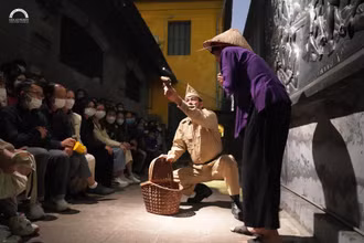 Khách du lịch tham gia tour du lịch đêm tại di tích Nhà tù Hỏa Lò.