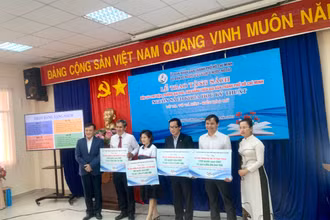 Bà Lê Thị Mỹ Châu (bìa phải), vợ Tiến sĩ Võ Tá Hân, trao sách cho các đơn vị.