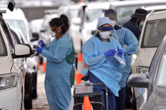 Nhân viên y tế lấy mẫu xét nghiệm Covid-19 cho người dân tại Sydney, Australia. (Ảnh: AFP/TTXVN)