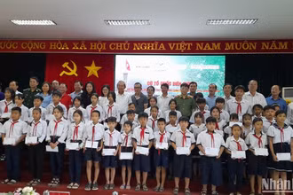 Nguyên lãnh đạo Trung ương, lãnh đạo địa phương và nhà tài trợ chụp hình với cho học sinh dân tộc thiểu số, học sinh nghèo khu vực biên giới tỉnh Long An.