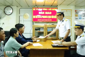 Đại diện Vùng 4 Hải quân bàn giao biên bản ngư dân Phú Yên cho ngư dân và địa phương. (Ảnh: TTXVN phát)