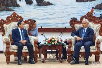 Đồng chí Đinh Như Hoan, Phó Tổng Biên tập Báo Nhân Dân chào xã giao đồng chí Trưởng Ban Tuyên huấn Trung ương Đảng Nhân dân Cách mạng Lào. Ảnh: Hải Tiến