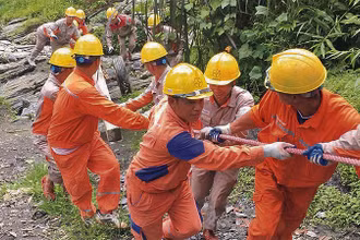 Công nhân Công ty Điện lực Hà Giang kéo điện lên vùng cao.