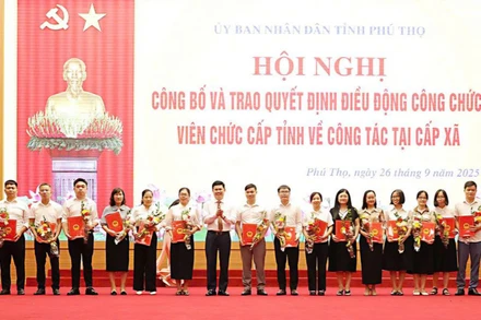 Giám đốc Sở Nội vụ Trần Việt Cường tặng hoa cho công chức được điều động về xã. 