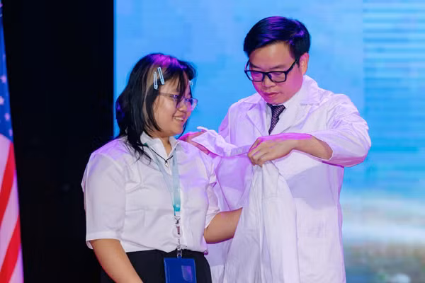 Giáo sư, Tiến sĩ, bác sĩ Trần Trung Dũng trao áo Blouse trắng cho tân sinh viên Y khoa Hoàng Thị Linh Nhi tại lễ khai giảng VinUni.