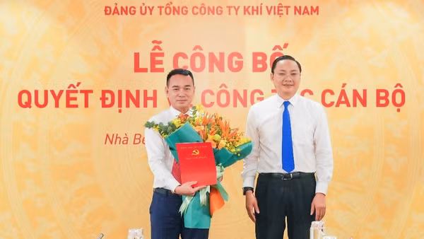Đồng chí Phan Ngọc Phúc, Bí thư Đảng ủy, Chủ tịch Hội đồng nhân dân xã Nhà Bè trao Quyết định chỉ định giữ chức Phó Bí thư Đảng ủy PV GAS nhiệm kỳ 2025-2030 và tặng hoa chúc mừng đồng chí Dương Trí Hội. (Ảnh: PV GAS)