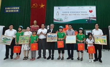 Các nhà tài trợ tặng quà, mũ bảo hiểm cho trẻ em đặc biệt khó khăn.