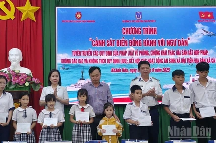 Lãnh đạo Ban Tuyên giáo và Dân vận Tỉnh ủy Khánh Hòa và đại diện lãnh đạo Hải đoàn 32, Bộ Tư lệnh Vùng Cảnh sát biển 3 tặng quà cho học sinh là con ngư dân xã Cà Ná. (Ảnh: NGUYỄN TRUNG)