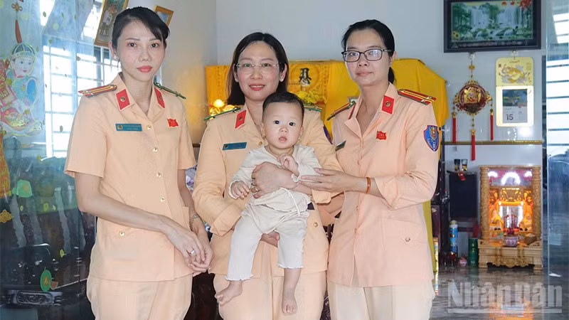 Cháu Lê Tiên bên vòng tay yêu thương của cán bộ, chiến sĩ cảnh sát giao thông.