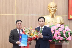 Chủ tịch Ủy ban nhân dân tỉnh Quảng Ngãi Nguyễn Hoàng Giang trao quyết định và tặng hoa chúc mừng đồng chí Nguyễn Văn Trọng.