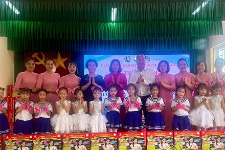 Đại diện Quỹ Bảo trợ trẻ em Việt Nam và các nhà tài trợ trao quà cho trẻ em Trường mầm non Yên Nam. (Ảnh NFVC)