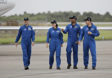 Bốn phi hành gia đi bộ sau khi đến Trung tâm Vũ trụ Kennedy. Họ sẽ được phóng trên tàu vũ trụ Crew Dragon của SpaceX chuyến chính thức đầu tiên tới Trạm vũ trụ quốc tế dự kiến vào ngày 14-11. Ảnh: AP.