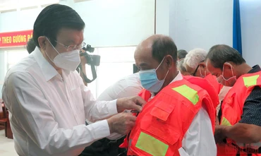 Nguyên Chủ tịch nước Trương Tấn Sang trao áo phao cứu sinh cho ngư dân.